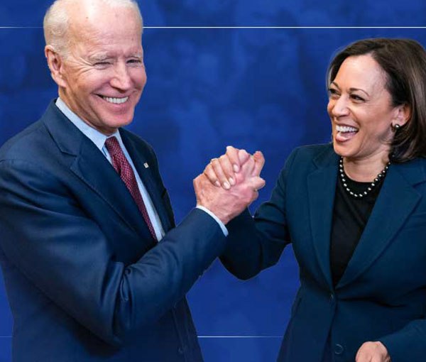 Joe Biden and Kamala Harris together on stage, hands raised.