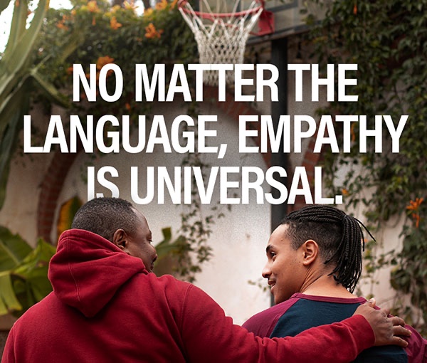 Campaign post reading No matter the language, empathy is universal, over two friends walking with an arm around a shoulder.